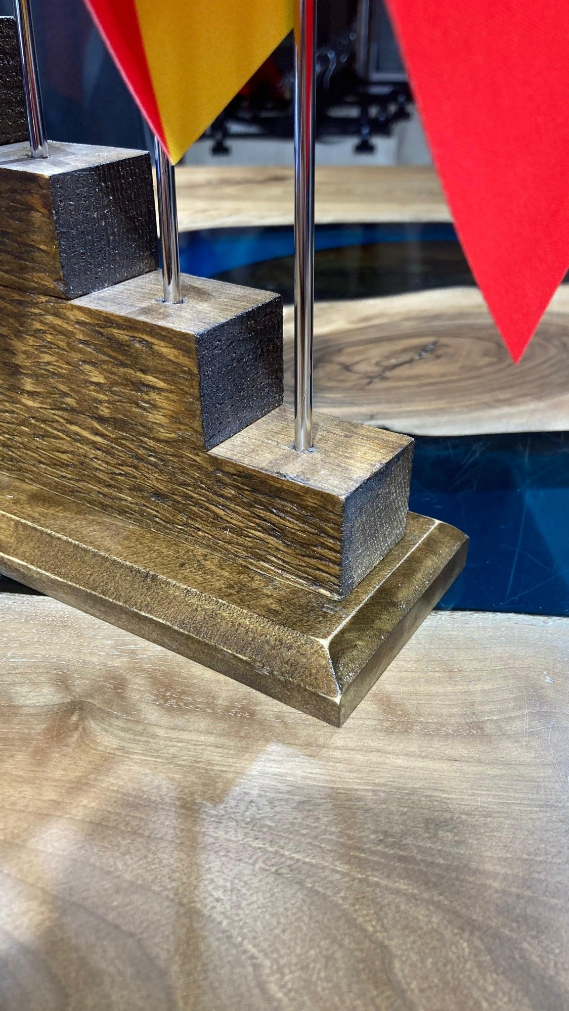 Close-up of the pine base steps with chrome flag poles