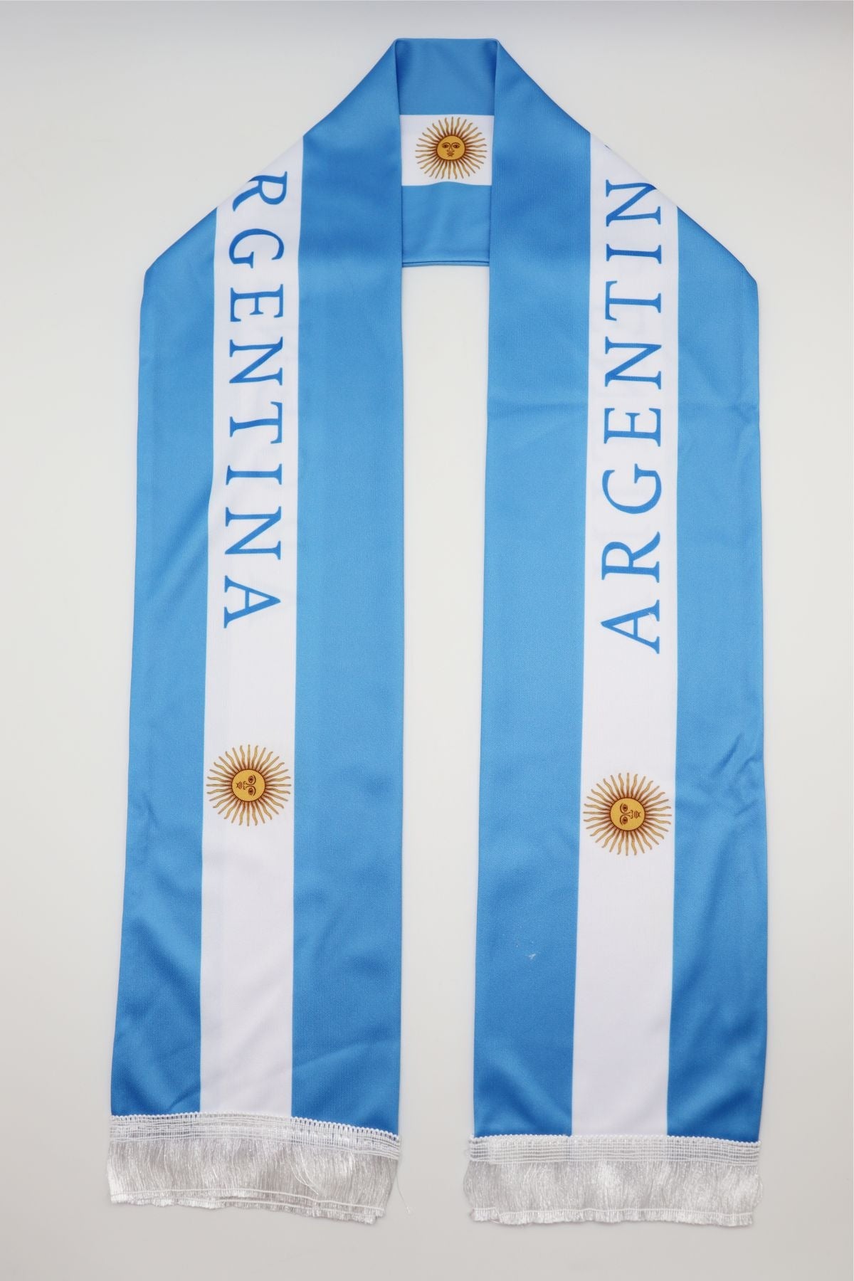 Argentina Flag Satin Soccer Scarf laid flat, full length with ARGENTINA lettering and white fringes